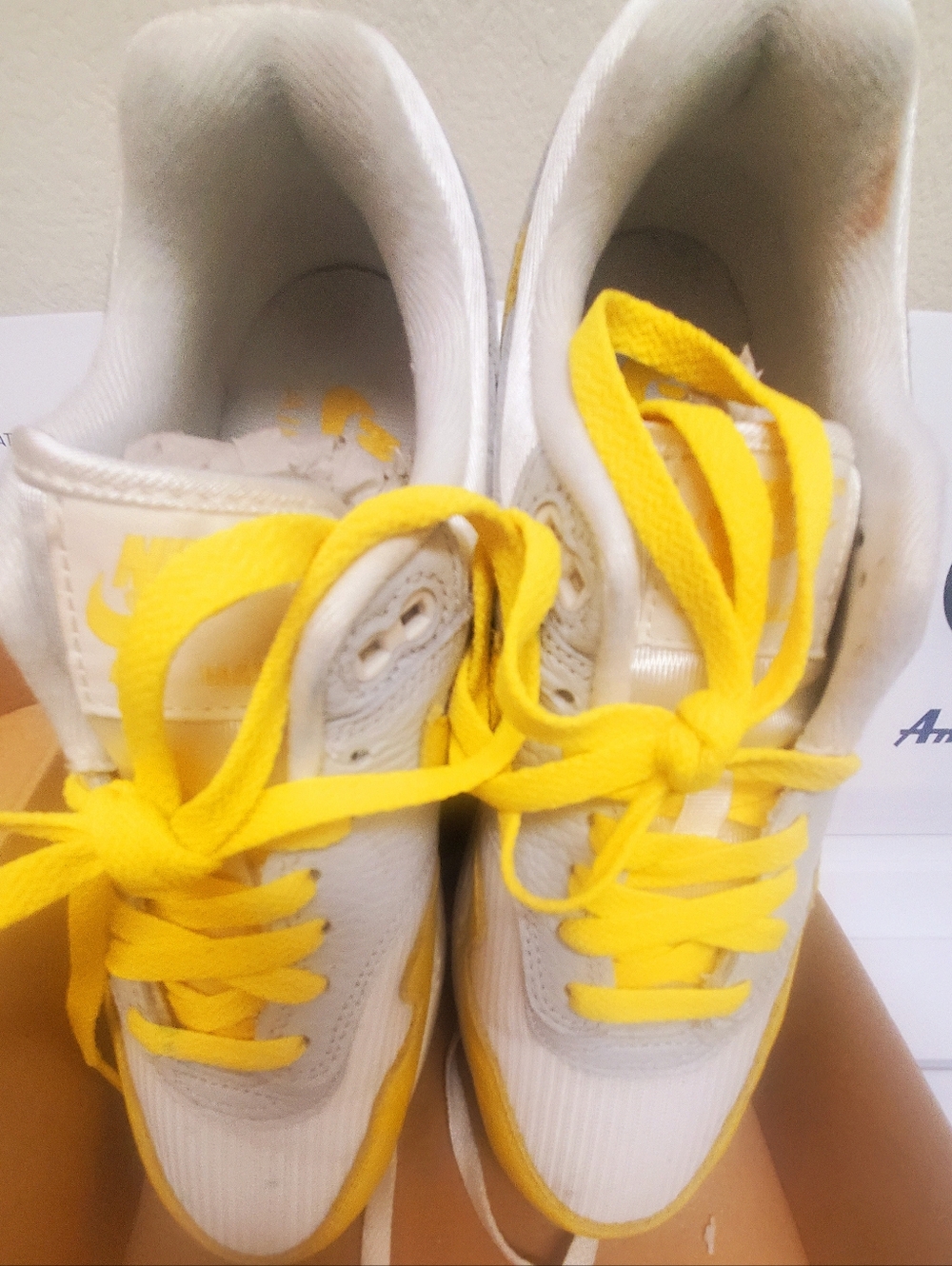 White and Yellow Lace-Up Nike Sneakers